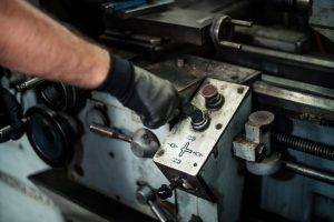 turner turning on the drill in a workshop